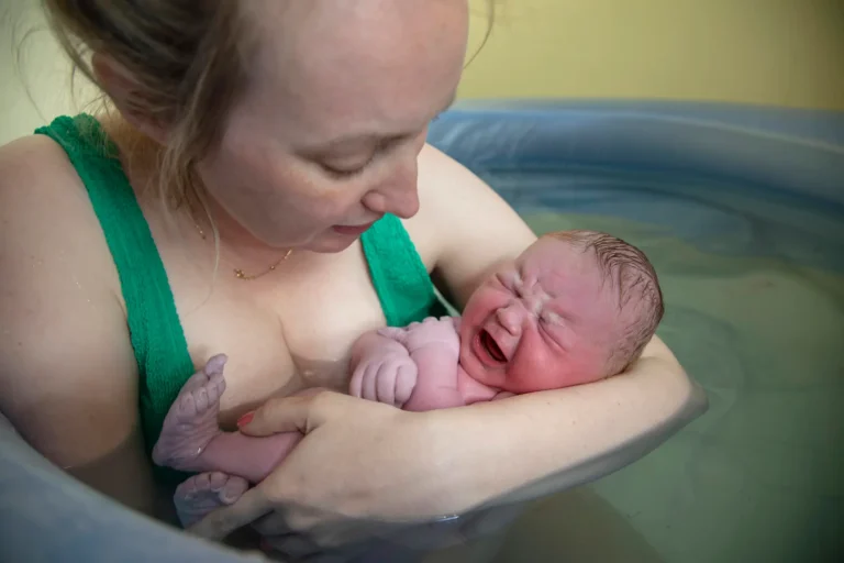 Mum and new born in birth pool